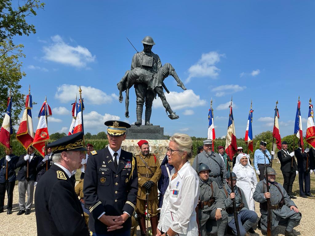 People stand in front of a WWI monument
