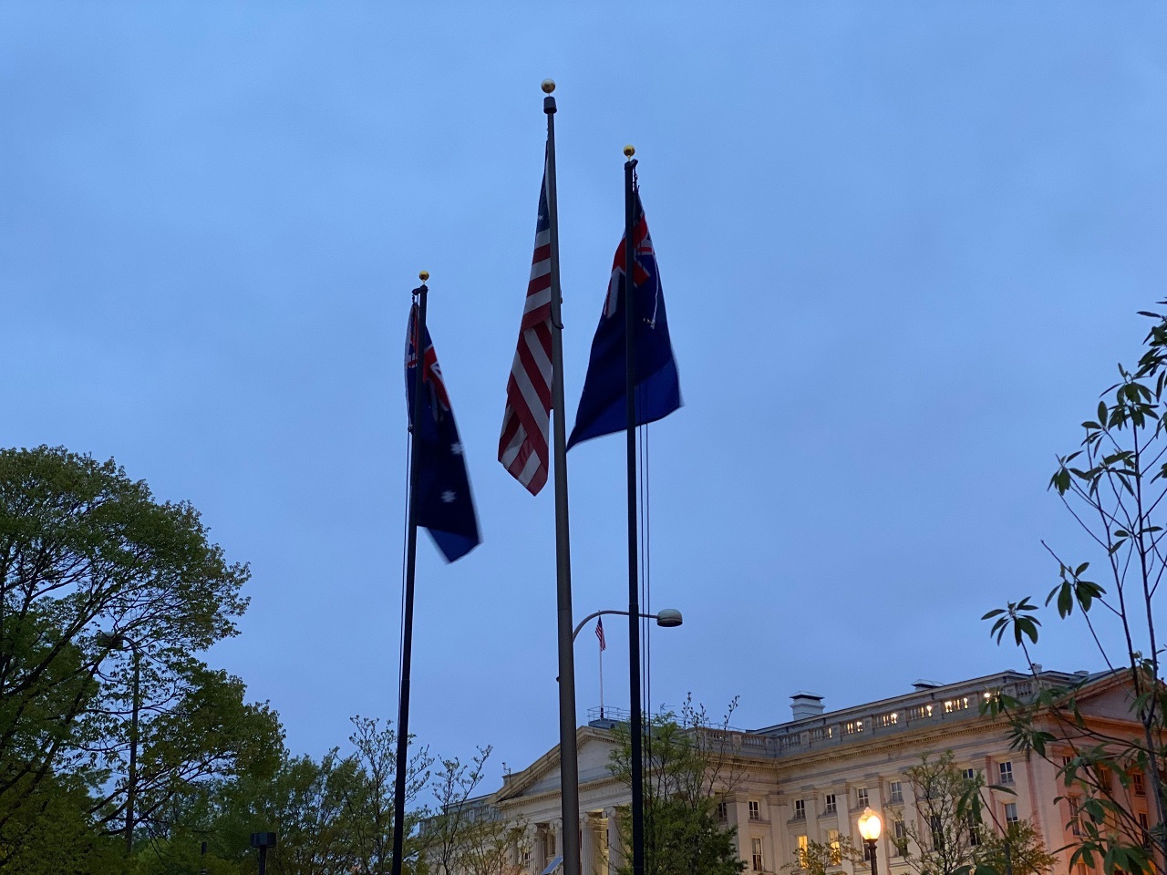 New Zealand, US, and Australia flags at dawn