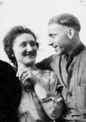 A man and woman stand together in a black and white photo