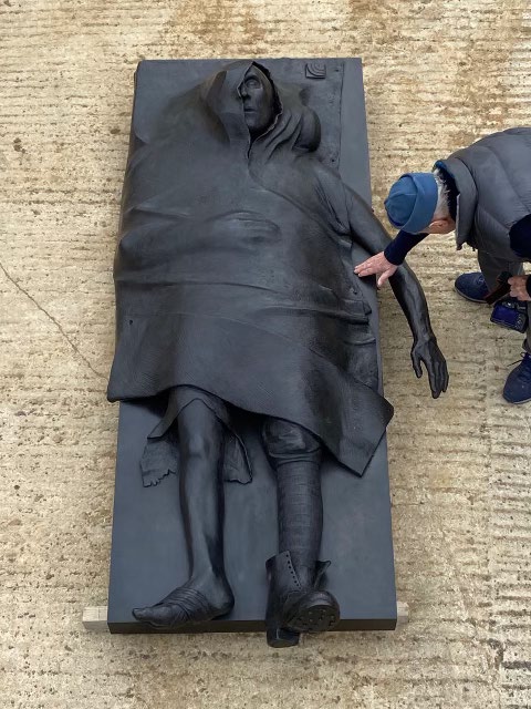 The sculptor inspects a statue