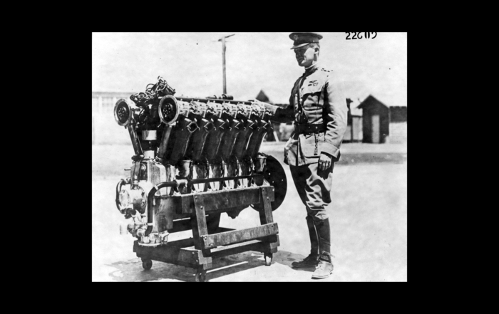 Maj. Henry H Arnold standing beside first Liberty Engine