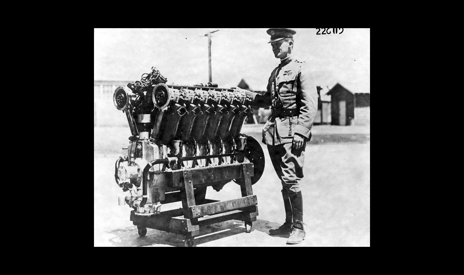 Maj. Henry H Arnold standing beside first Liberty Engine
