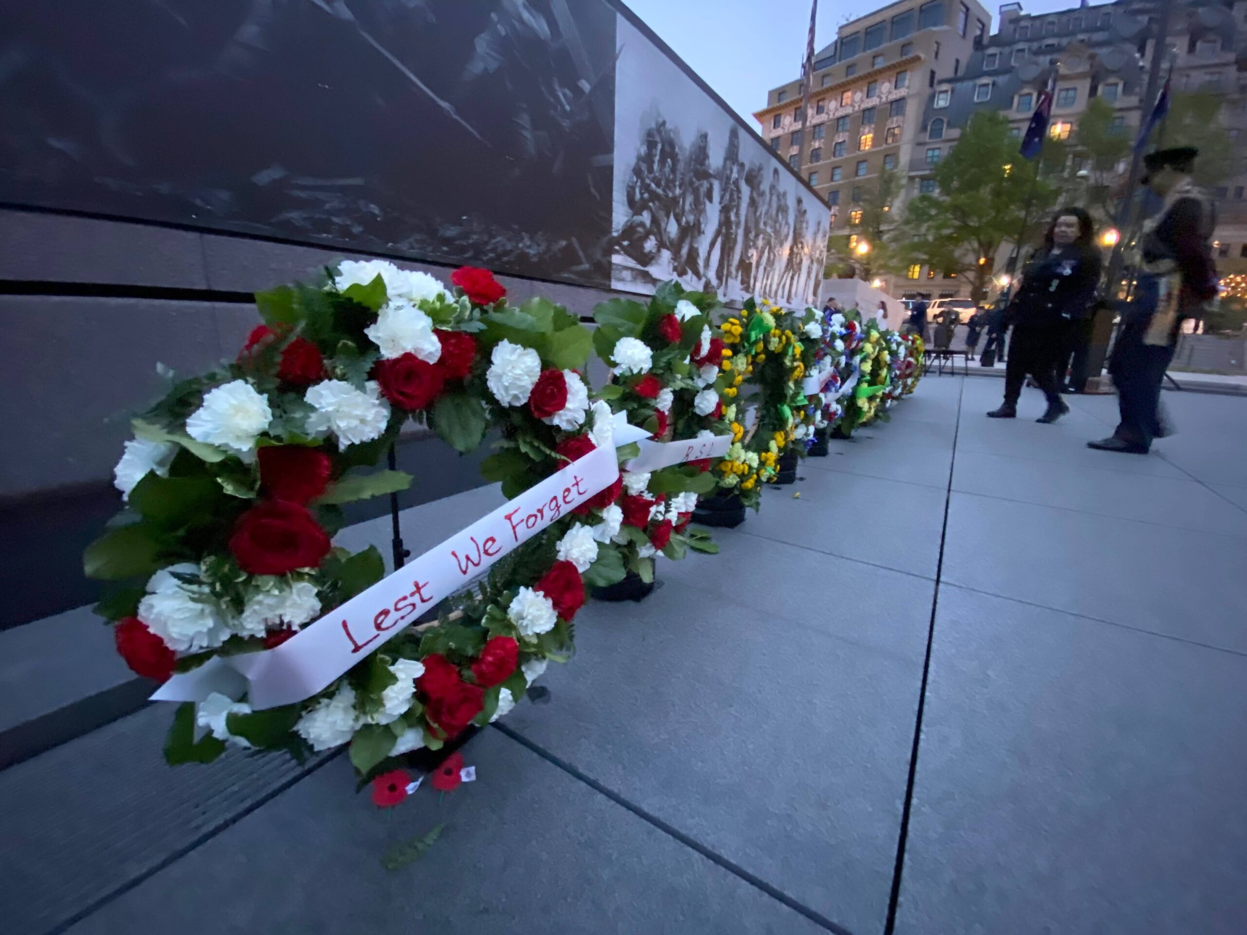 A close-up on "Lest We Forget" wreaths